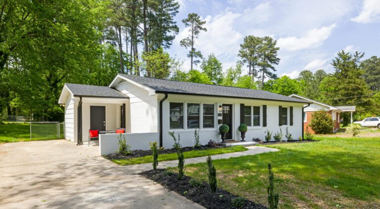 Modern suburban home with spacious yard and elegant landscaping.